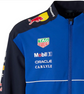 Close-up of the blue chest and navy shoulder panels on a motorsport-inspired bomber jacket