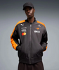 Model wearing a black and orange motorsport-inspired bomber jacket from the front